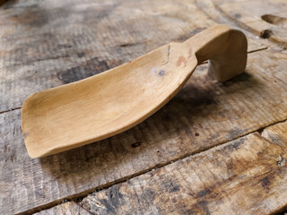 a wooden rice ladle on a wooden table