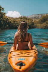 Woman paddling kayak in river through picturesque landscape for a serene outdoor adventure