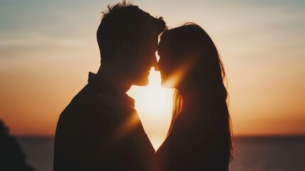 Close-up of a couple's silhouette against a sunset backdrop.