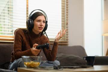 Upset young woman feeling disappointed losing online video games