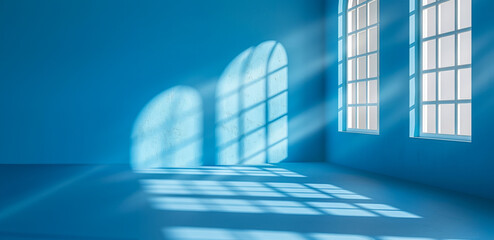 A blue room with two windows and a shadow on the wall