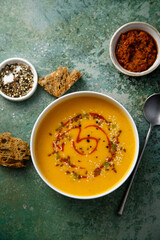 Homemade pumpkin soup with red pesto