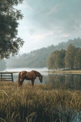 A horse grazing by the riverbank, immersed in a peaceful moment of enjoying fresh grass 🐴🌾✨ Nature's serenity meets the grace of these majestic creatures. #RiversideGrazing