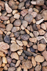 Smooth round pebbles texture background. Pebble sea beach close-up, dark wet pebble and gray dry pebble. High quality photo