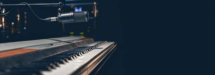Musical background with piano keys and microphone, space for a text. - obrazy, fototapety, plakaty
