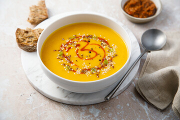 Homemade pumpkin soup with red pesto