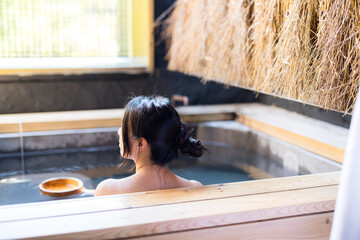 Asian Young woman relaxing in hot spring