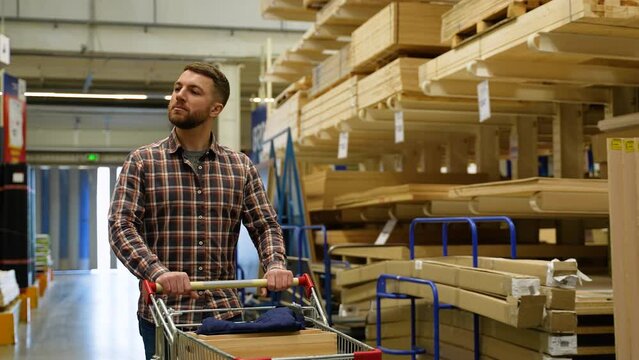 Customer walking with shopping cart in hardware store