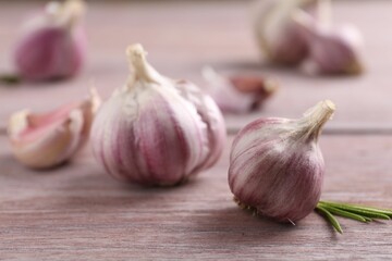 Bulbs of fresh garlic on wooden table, selective focus