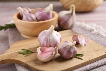 Bulbs and cloves of fresh garlic on table, closeup