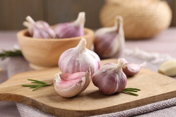 Bulbs and cloves of fresh garlic on table, closeup
