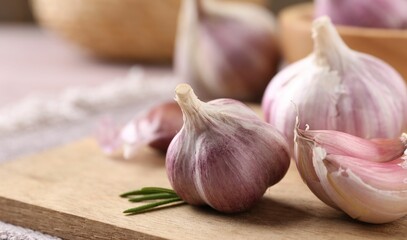 Bulbs and cloves of fresh garlic on table, closeup. Space for text