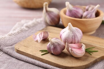 Bulbs and cloves of fresh garlic on table, closeup