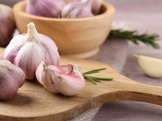 Bulbs and cloves of fresh garlic on table, closeup