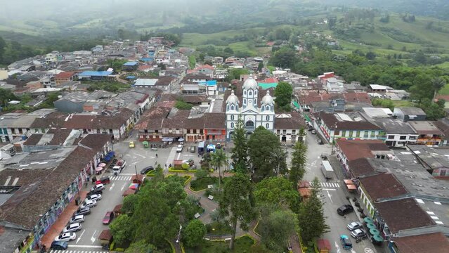 Aerial view flying over Parque Bolivar and the church Parroquia Inmaculada Concepci&oacute;n de Filandia in the Andean town of Filandia in the Quind&iacute;o department of Colombia