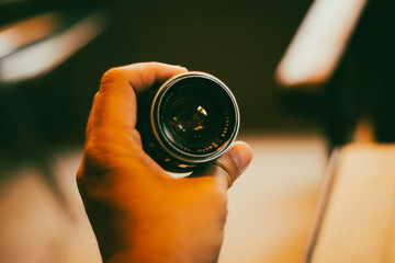 Old vintage camera,Close-up of hand holding camera lens against sky,Close-up of hand holding camera...