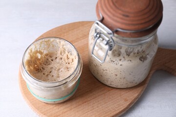 Sourdough starter in glass jars on light table