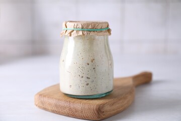Sourdough starter in glass jar on light table