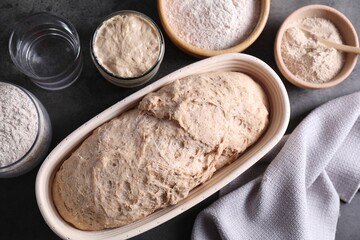 Fototapeta na wymiar Fresh sourdough, flour and water on grey table, flat lay