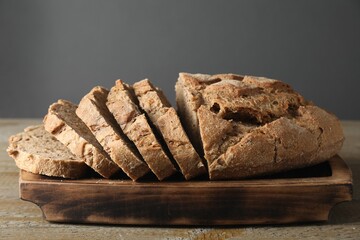 Freshly baked cut sourdough bread on wooden table