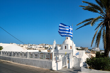 Greek flag fluttering in Karterádos Town, Santorini Island, Cyclades, Greece