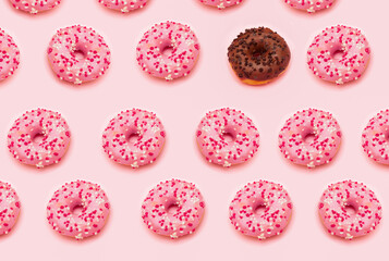 Fototapeta na wymiar Pattern of pink doughnuts and a single chocolate doughnut