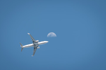 airplane and moon in the sky
