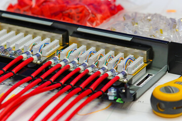 Patch panel with connected twisted pair wires. To connect an Ethernet signal in telecommunication systems. Soft focus.