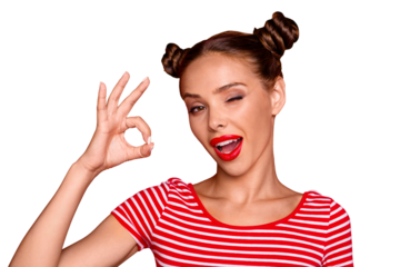 Close up portrait of happy girl with wide open mouth and wink eye gesturing ok sign isolated on vivid red background
