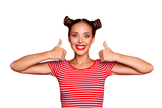 Advertising concept. Portrait of adorable happy girl with beaming smile looking in camera and showing thumbs up on both hands isolated on red bright background