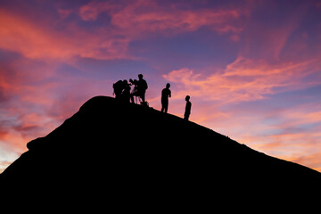 Silhouetted team conducting volcano research during picturesque sunset backdrop - obrazy, fototapety, plakaty