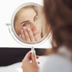 Woman, mirror and anti aging in home, bathroom and skincare or cosmetic dermatology for wrinkles....
