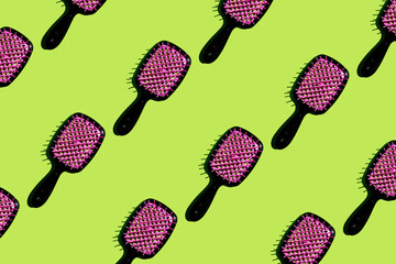 Bright and vibrant photo showcasing repeating collage of black and pink combs on sunny green...