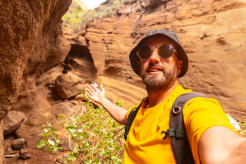 Selfie of a man enjoying in the limestone canyon Barranco de las Vacas in Gran Canaria, Canary...