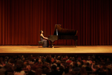 Classical, concert and woman with piano on a stage for performance, entertainment and talent show. Musician, creative artist and person playing instrument for melody, music and symphony for audience © peopleimages.com