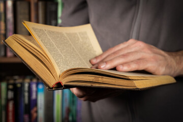 Men opening and reading a old book, close up