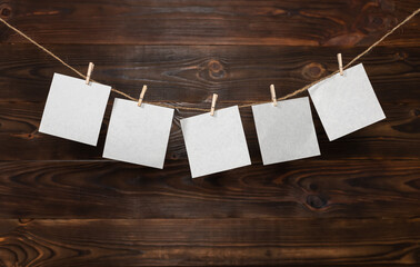 paper cards hanging on the rope on wooden background