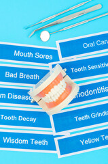 Dentures model with dental disease on blue.
