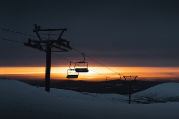 Fototapeta na wymiar A ski lift with a sunset in the background