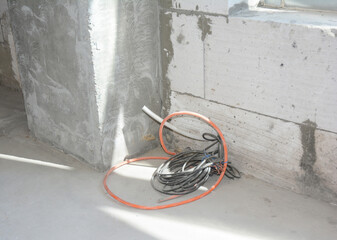 Close up on electric wire in concrete wall in  house construction site