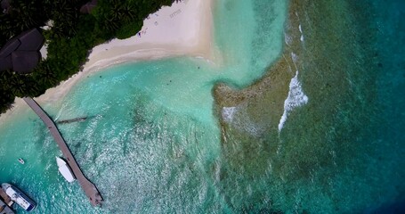 Aerial view of yachts near the pier on the shore of a tropical island in Asia