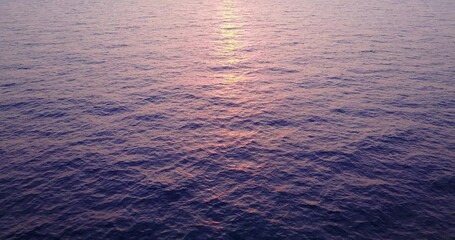 Rays of the setting sun over the ocean water in the Maldives