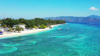 Fototapeta na wymiar Aerial drone view of a beautiful tropical island under a blue sky on a sunny day