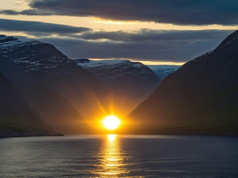 Midnight sun seen from a cruise ship in the fjords; Western Fjords, Norway