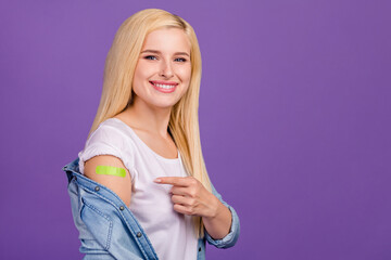 Portrait of attractive cheerful girl demonstrating plaster isolated over vibrant violet purple color background