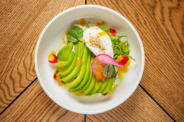 avocado with poached egg and sauce
