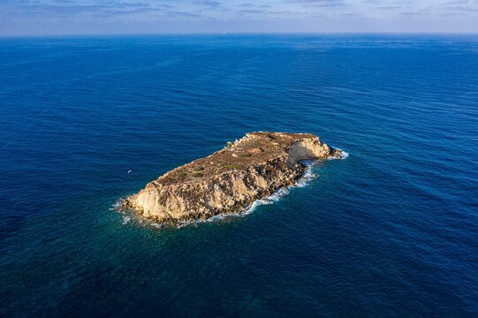 Top view of the inhabited Geronisos island surrounded by a blue seascape in Cyprus