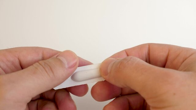 They cut the polyethylene package and take out the medicine in the form of a candle.