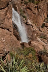 Stream of a waterfall flowing from a rocky cliff
