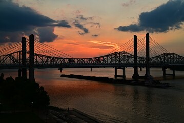 Abraham Lincoln Bridge over the Ohio River at sunset with a cloudy sky in the background, US